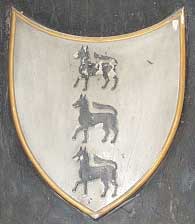 The crest of the Lovetts with the 3 wolves argent in honour of William Lovett's position as the King's Master of Wolfhounds.